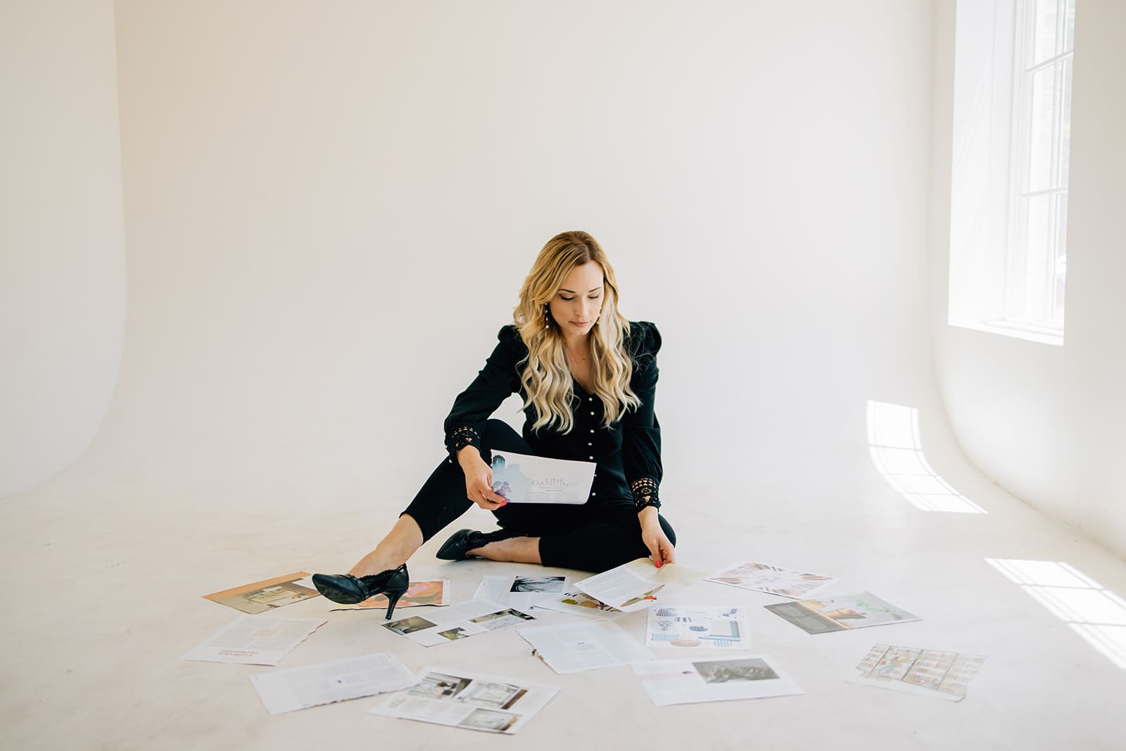 A woman sitting on the ground with papers